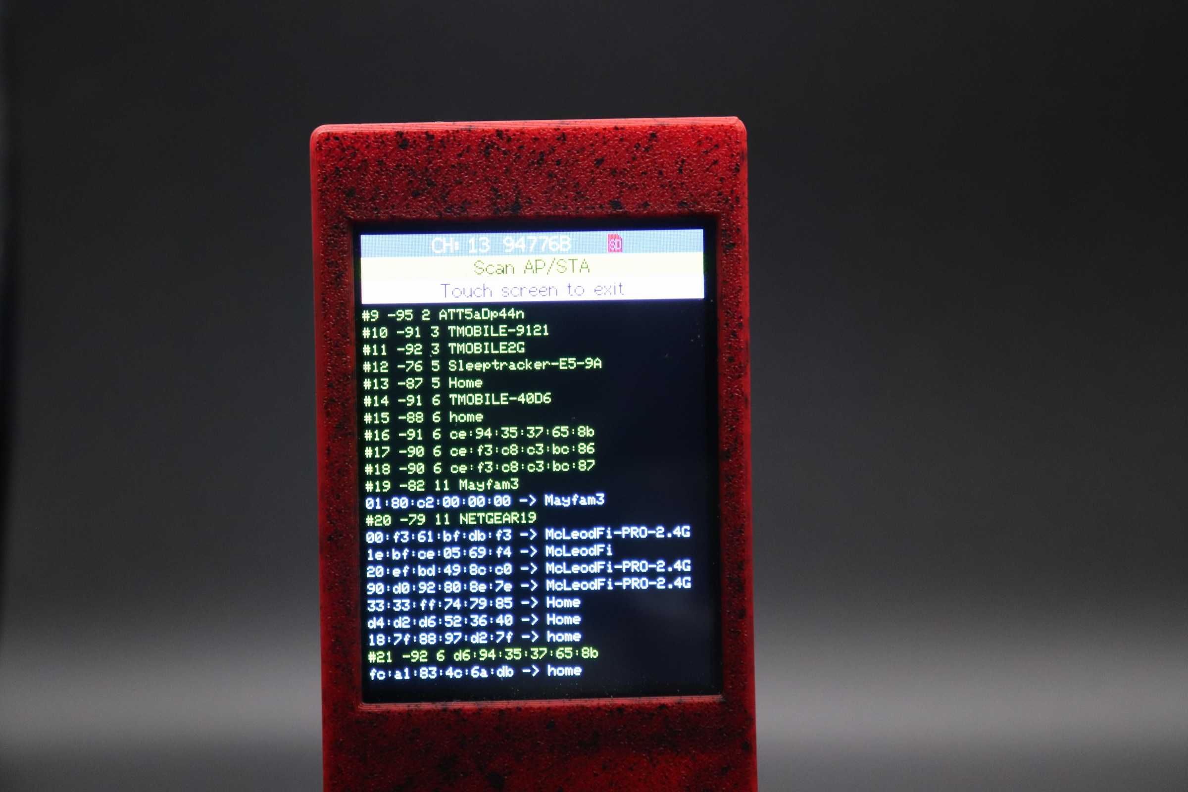 Red CYD device showing nearby network scan output